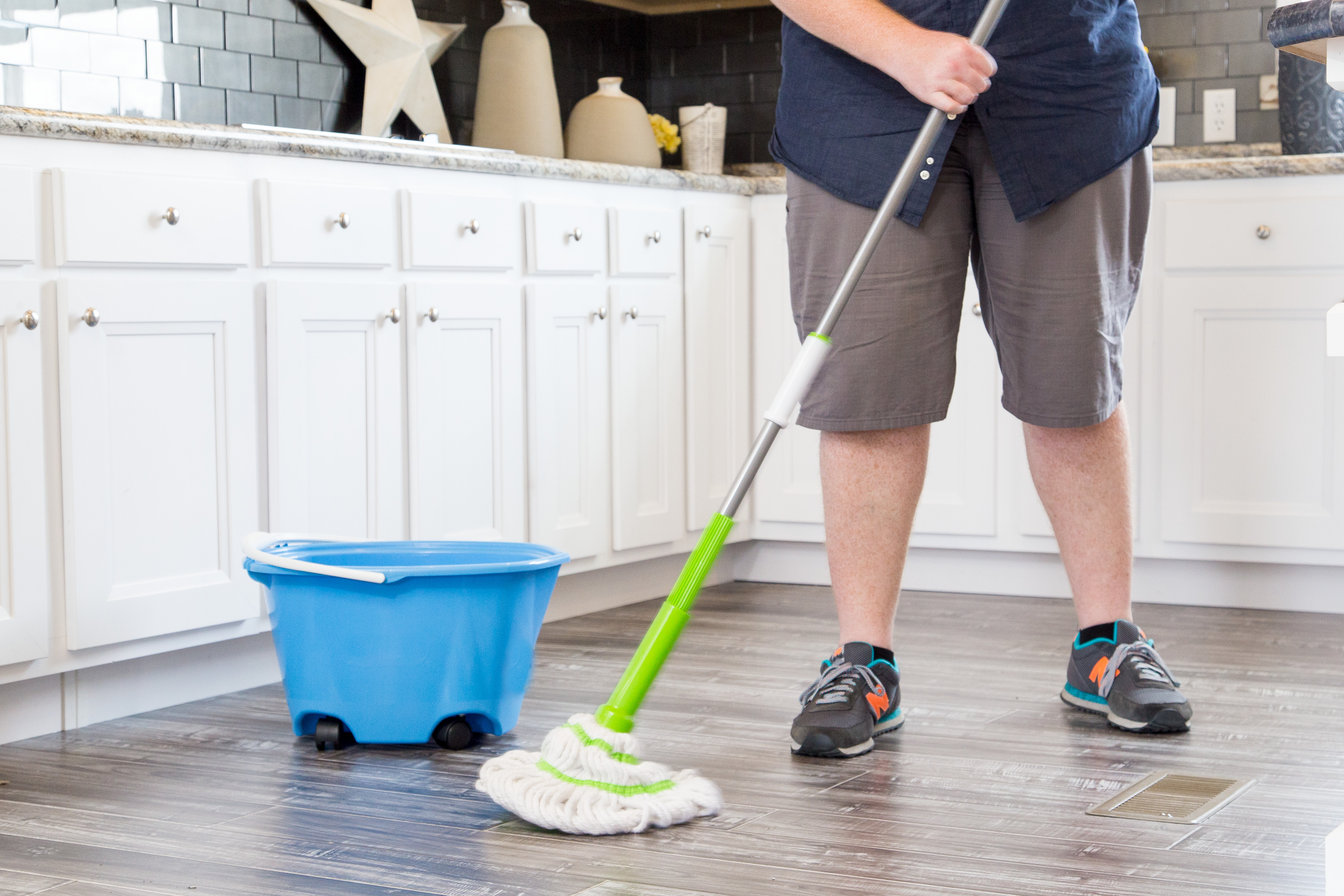 Person sweeping the floor.